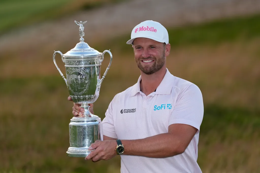 Wyndham Clark holds the trophy after winning the U.S. Open golf tournament at Shinnecock Hills Golf Club in Southampton, N.Y., Sunday, June 21, 2026.  