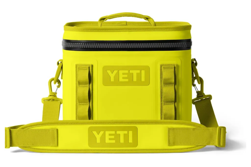 A yellow Yeti cooler with a black zipper and shoulder strap.