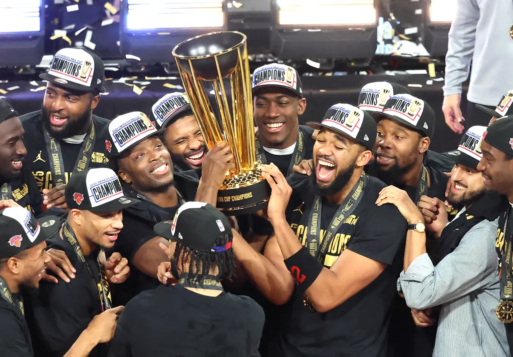 Karl-Anthony Towns and his teammates celebrating with the NBA Cup trophy after winning the NBA Cup Final.