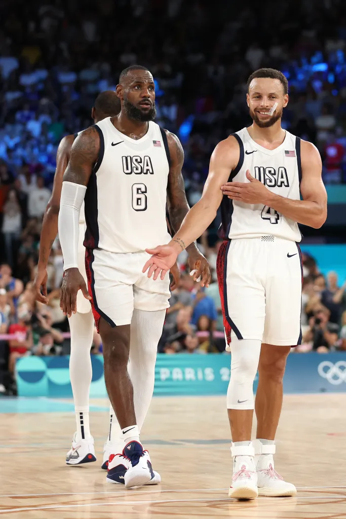 LeBron James and Stephen Curry in Team USA basketball uniforms on the court.