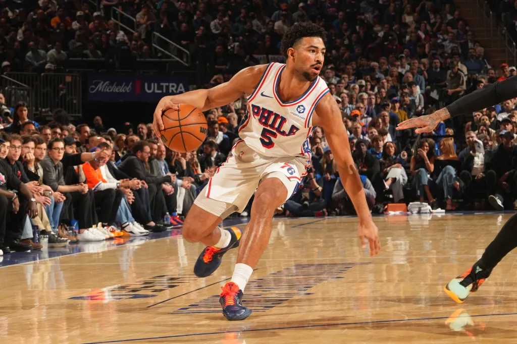 Basketball player Tyrese Maxey of the Philadelphia 76ers dribbling the ball during a game against the New York Knicks.