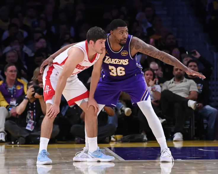 Marcus Smart of the Los Angeles Lakers and another player from the Houston Rockets on the basketball court.