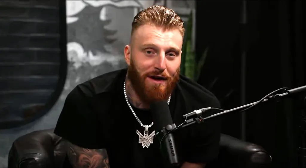 Maxx Crosby speaking into a microphone.