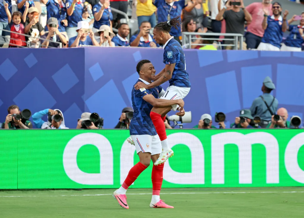 France forward Michael Olise (11) celebrating with Kylian Mbappé (10) after Mbappé scores his 2nd goal of the game.