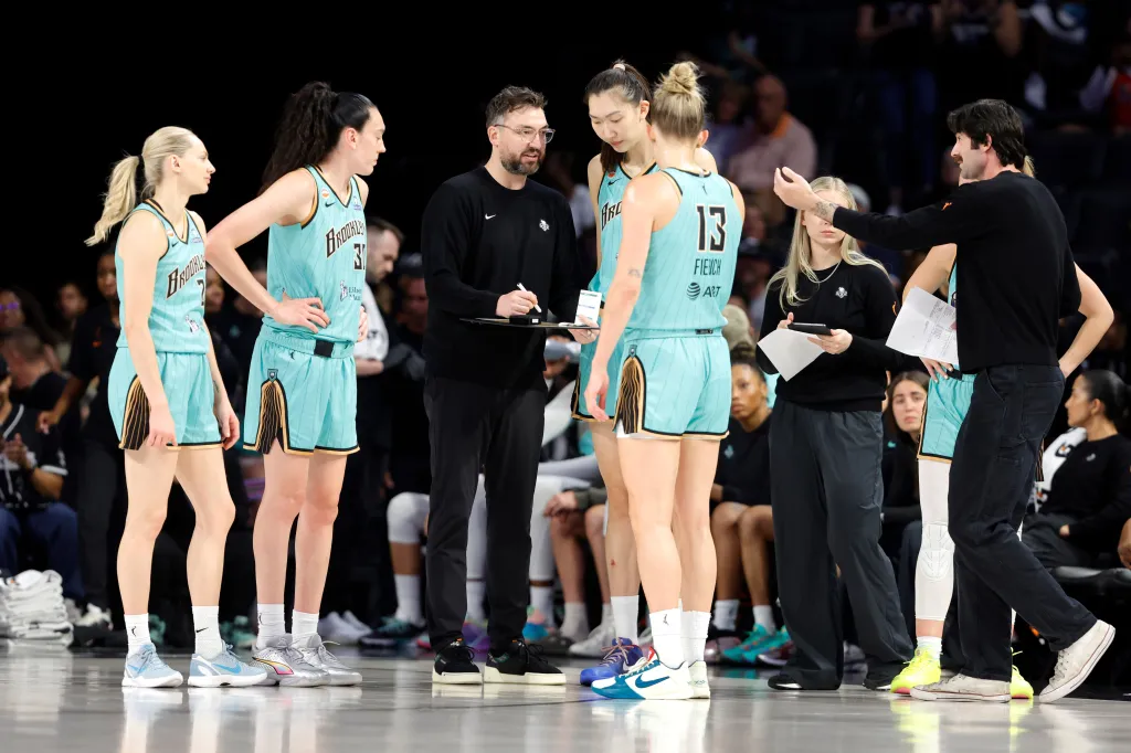 New York Liberty head coach Chris DeMarco talks to players during a timeout.