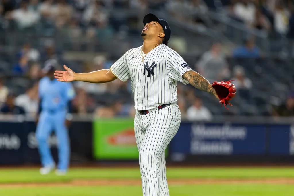 New York Yankees pitcher Yovanny Cruz reacts after ending the eighth inning against the Toronto Blue Jays.