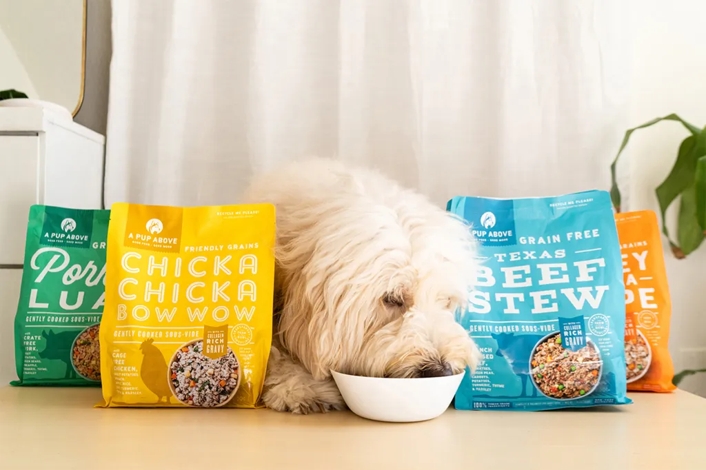A dog eating A Pup Above from a bowl.