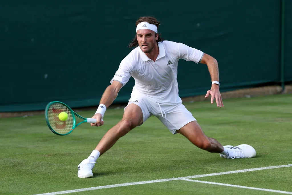Stefanos Tsitsipas playing a forehand at Wimbledon.